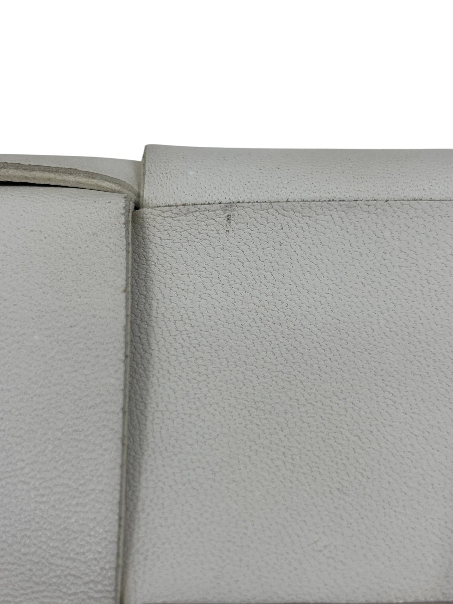 Close-up of white leather texture on a Posh Purse Co Bottega Veneta Cassette bag showing minor surface wear