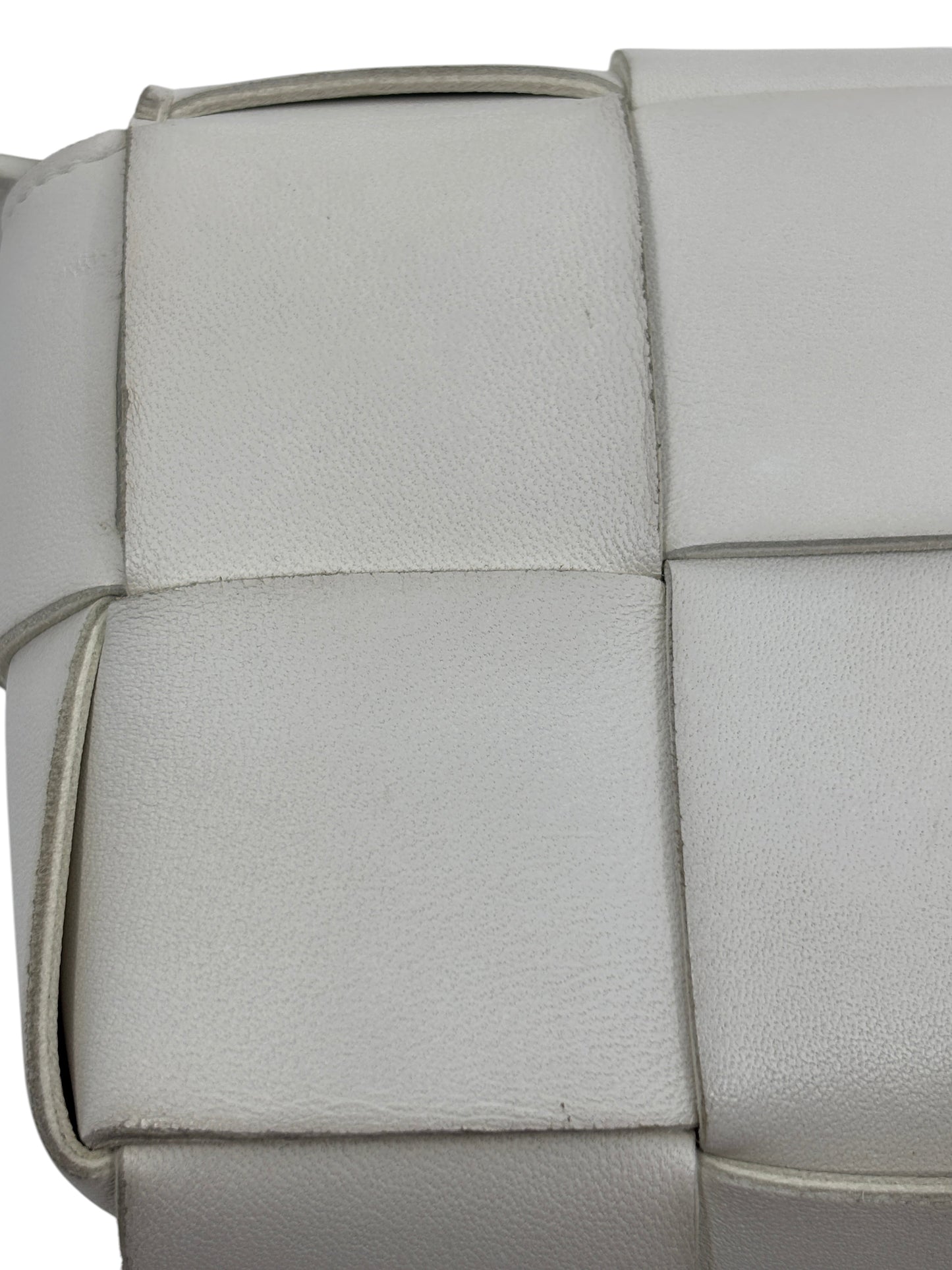 Close-up of white Bottega Veneta Cassette bag featuring signature Intrecciato woven leather from Posh Purse Co