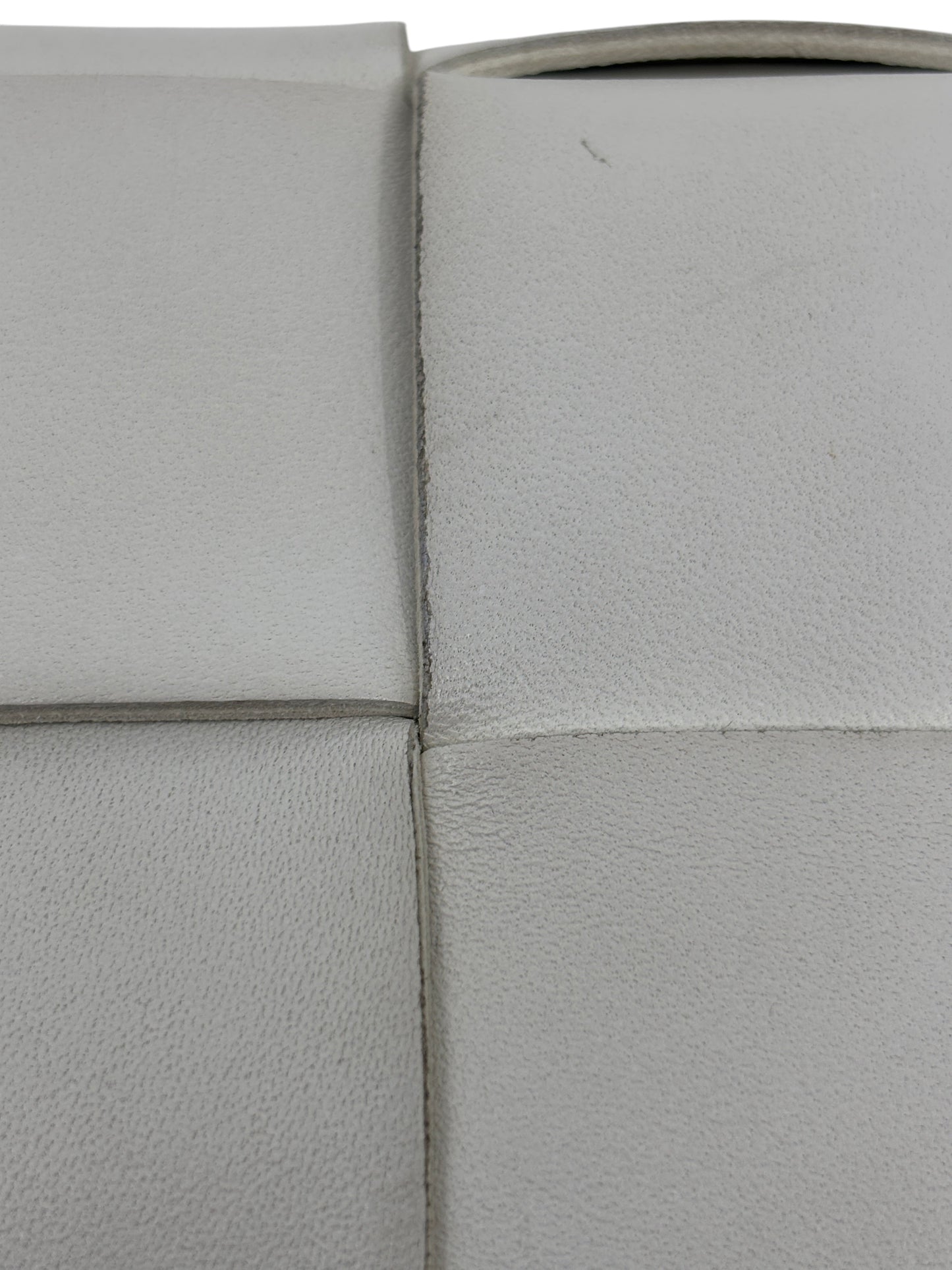 Close-up of white woven leather texture on a Posh Purse Co Bottega Veneta Cassette bag showing signature Intrecciato