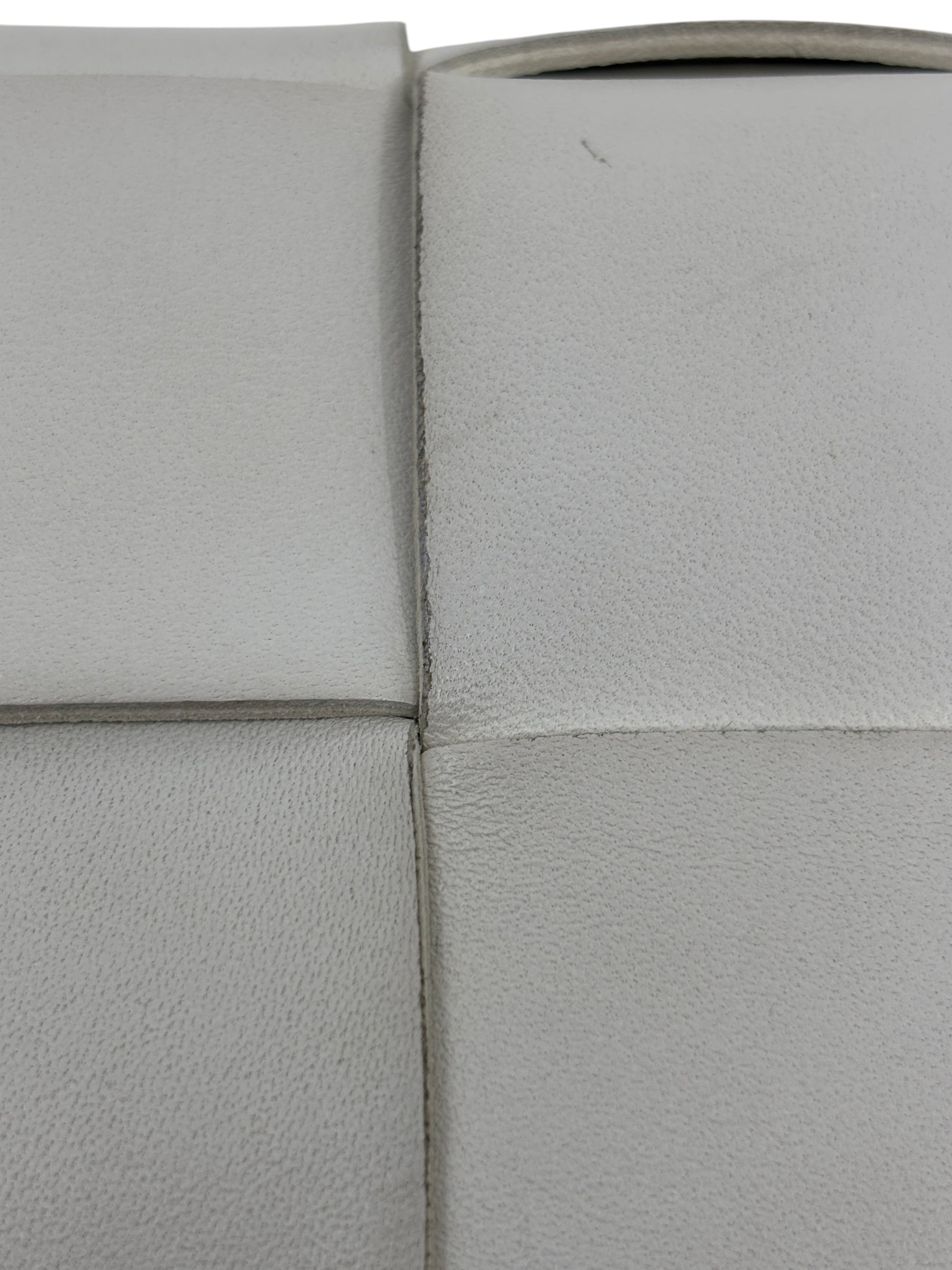Close-up of white woven leather texture on a Posh Purse Co Bottega Veneta Cassette bag showing signature Intrecciato