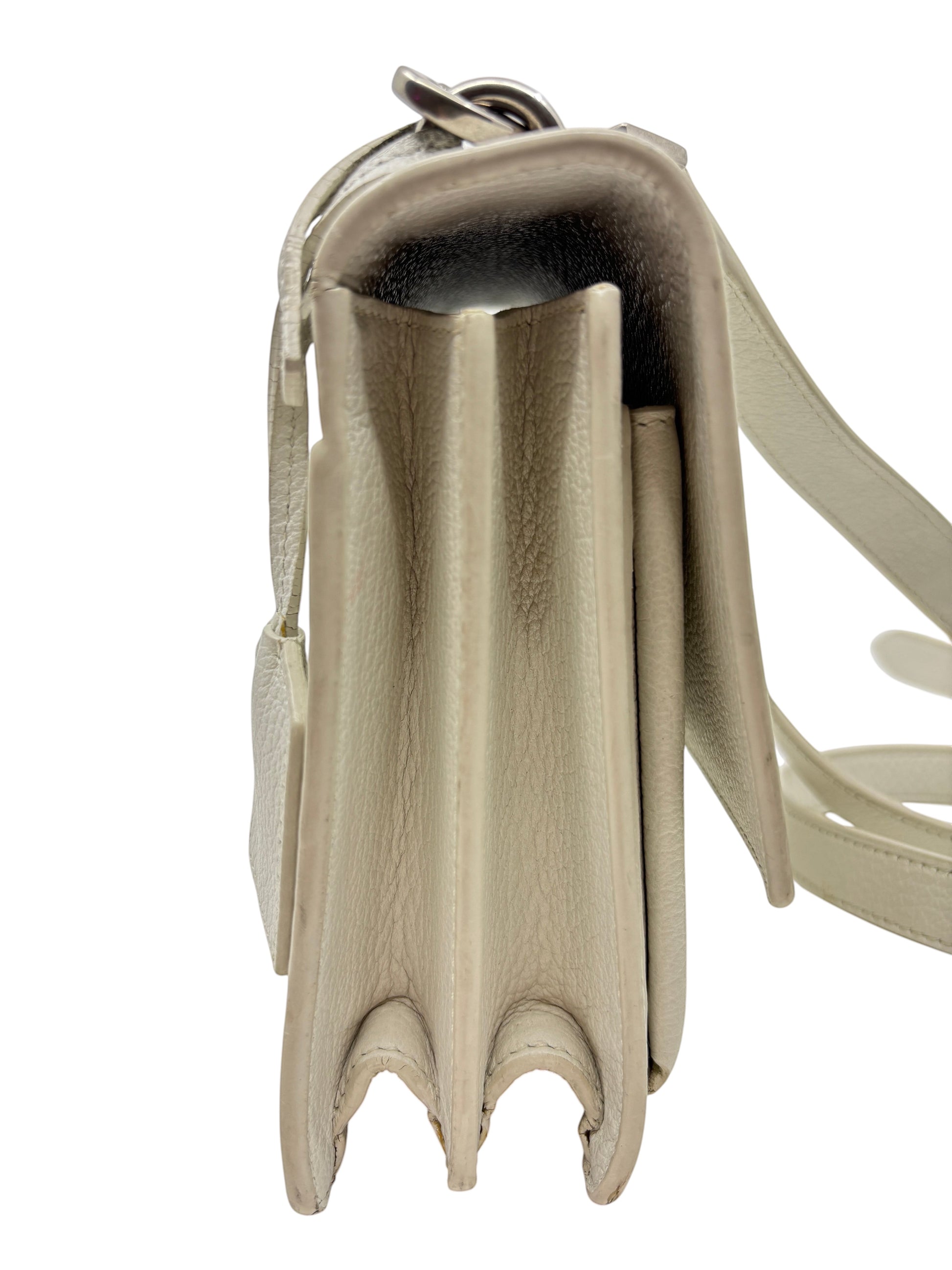 Side view of a white leather Saint Laurent Sunset medium crossbody bag from Posh Purse Co. showing gusset detail.