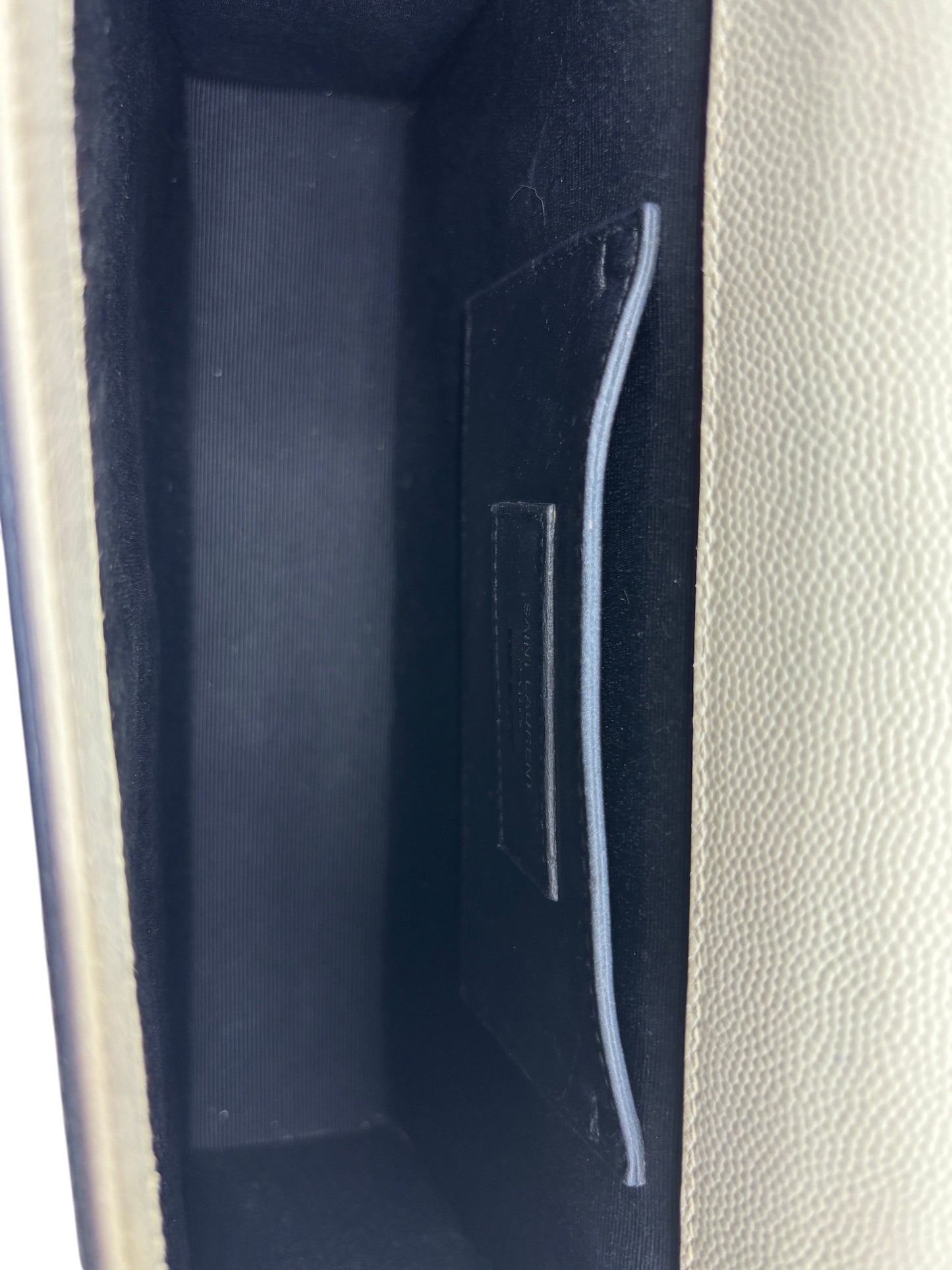Interior of Posh Purse Co. Saint Laurent Kate crossbody bag featuring black lining and a leather slip pocket
