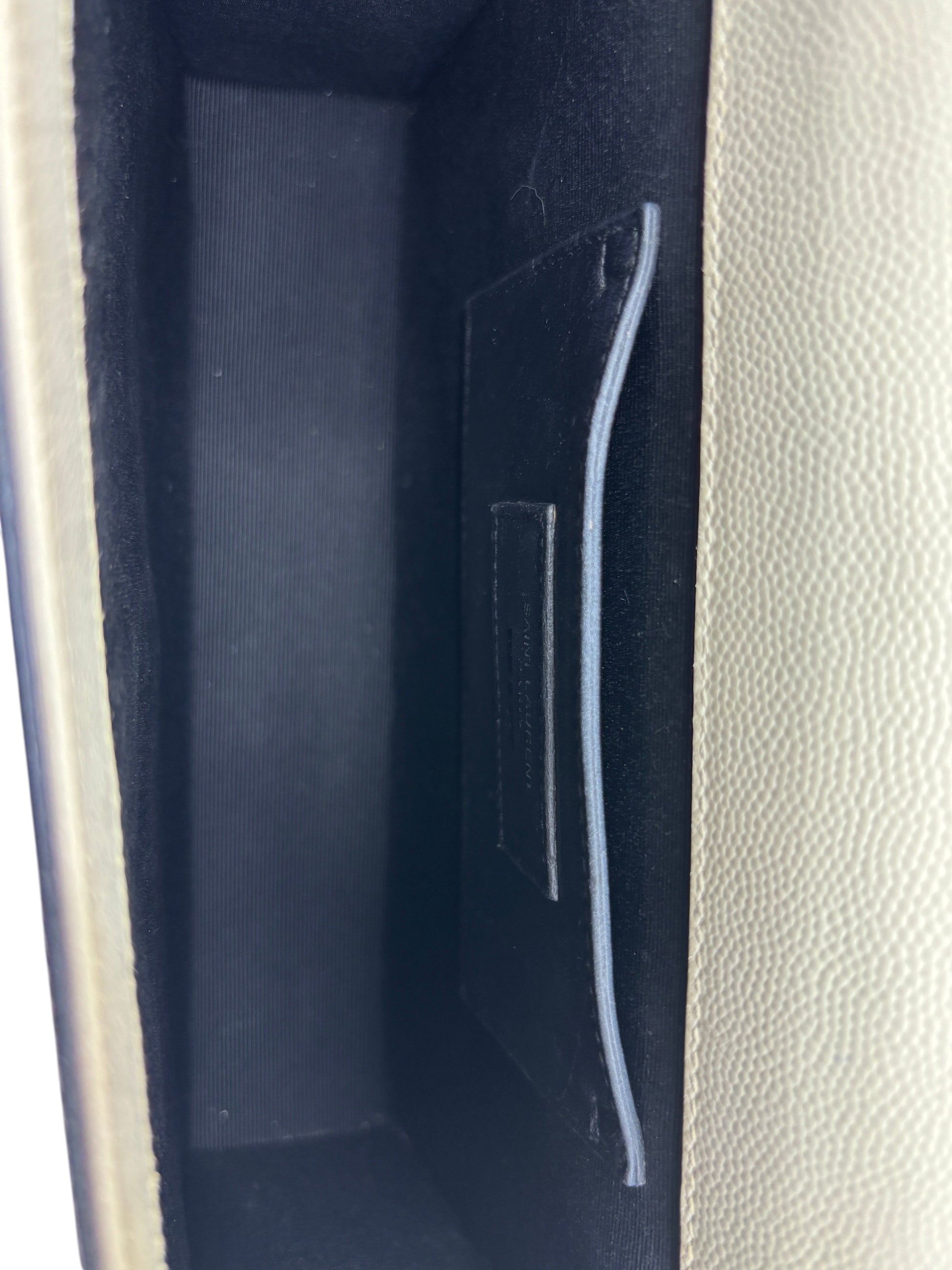Interior of Posh Purse Co. Saint Laurent Kate crossbody bag featuring black lining and a leather slip pocket