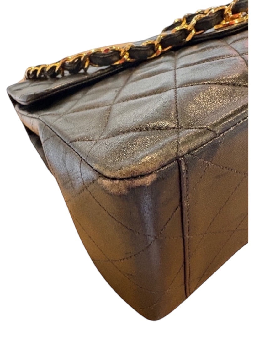 Posh Purse Co black calfskin jumbo flap bag with gold hardware and diamond quilting. Shows corner wear.