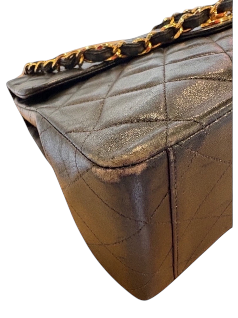 Posh Purse Co black calfskin jumbo flap bag with gold hardware and diamond quilting. Shows corner wear.