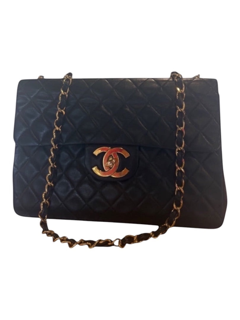 Posh Purse Co black calfskin jumbo flap bag with gold hardware and diamond quilting.