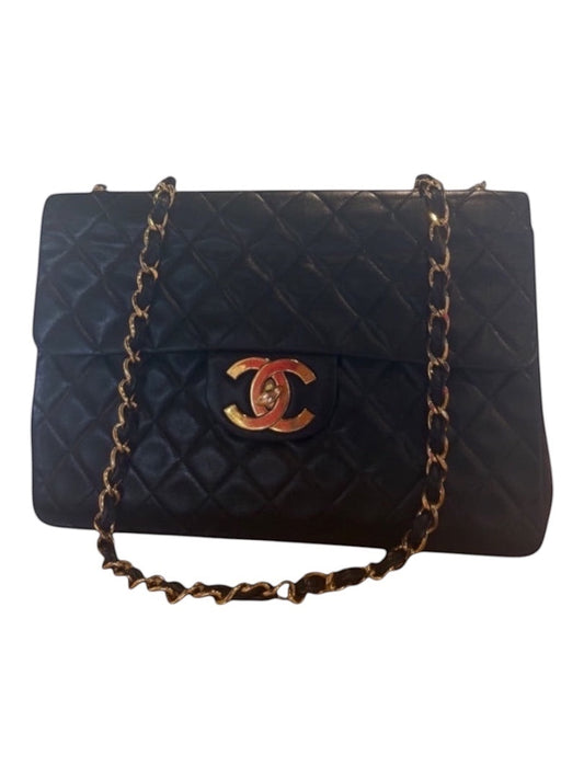 Posh Purse Co black calfskin jumbo flap bag with gold hardware and diamond quilting.