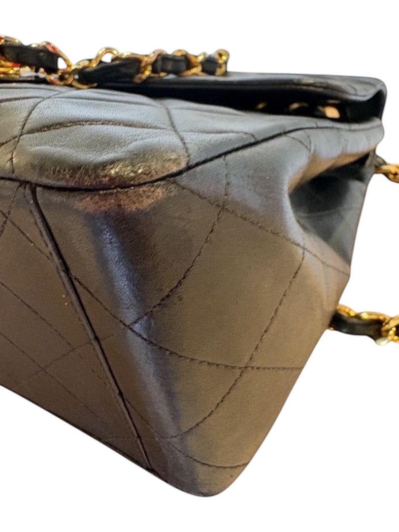 Posh Purse Co black quilted calfskin jumbo flap bag with gold hardware and chain strap.
