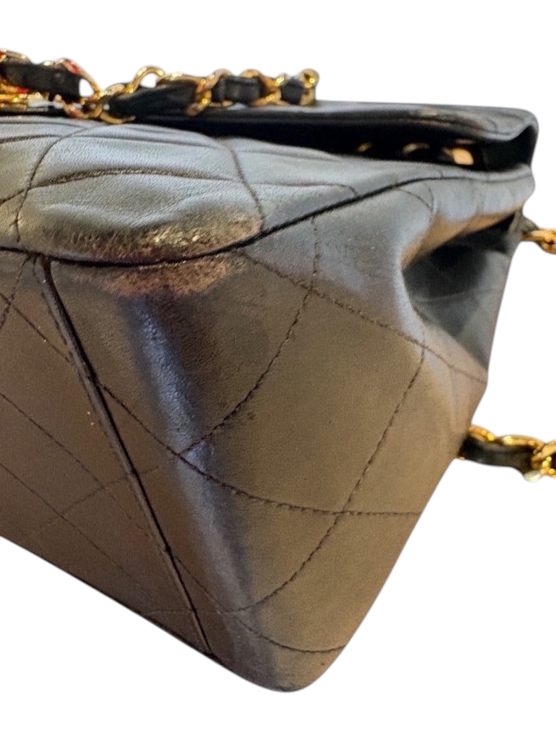 Posh Purse Co black quilted calfskin jumbo flap bag with gold hardware and chain strap.