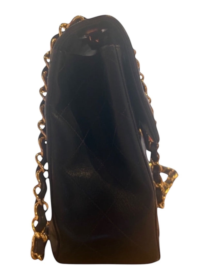 Posh Purse Co black quilted calfskin jumbo flap bag with gold hardware and chain strap.