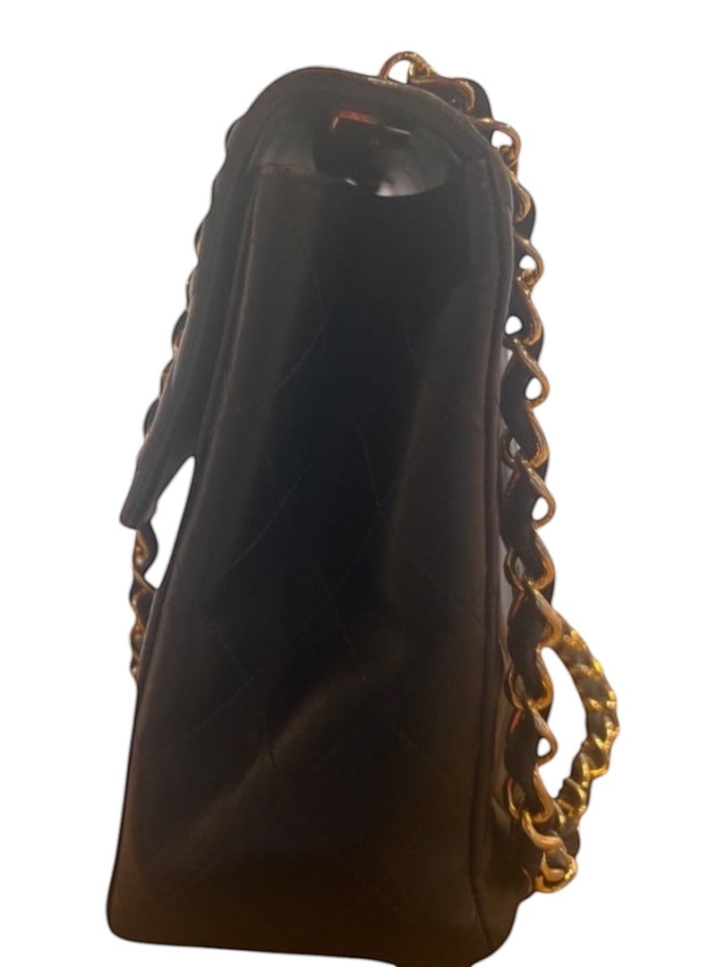 Posh Purse Co black calfskin jumbo flap bag with gold hardware and diamond quilting.