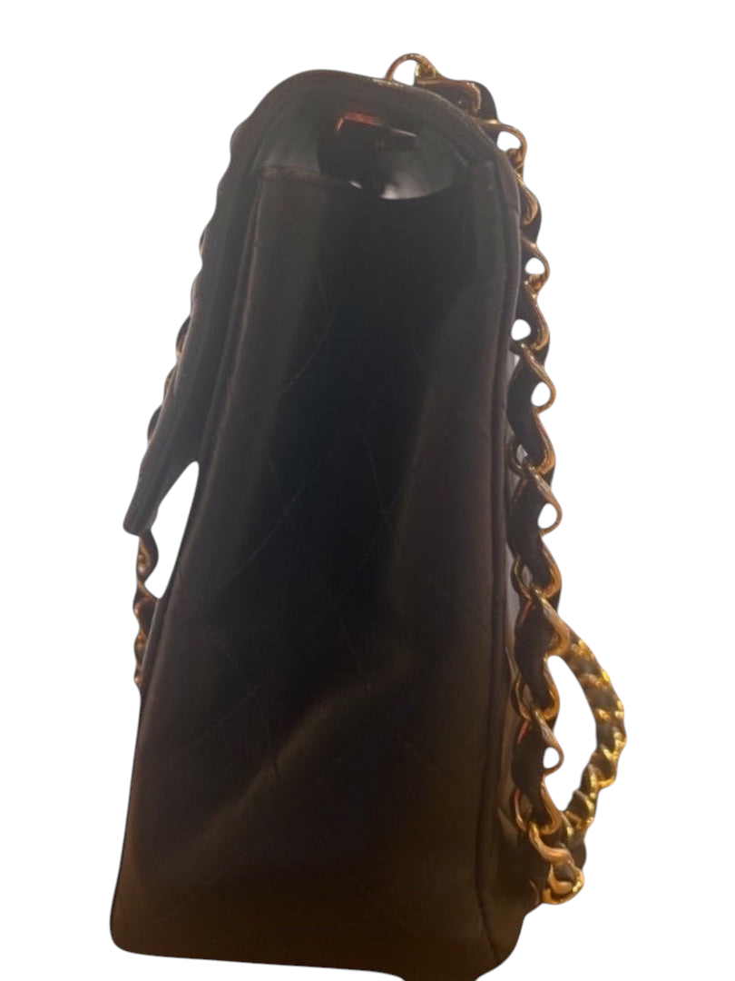 Posh Purse Co black calfskin jumbo flap bag with gold hardware and diamond quilting.
