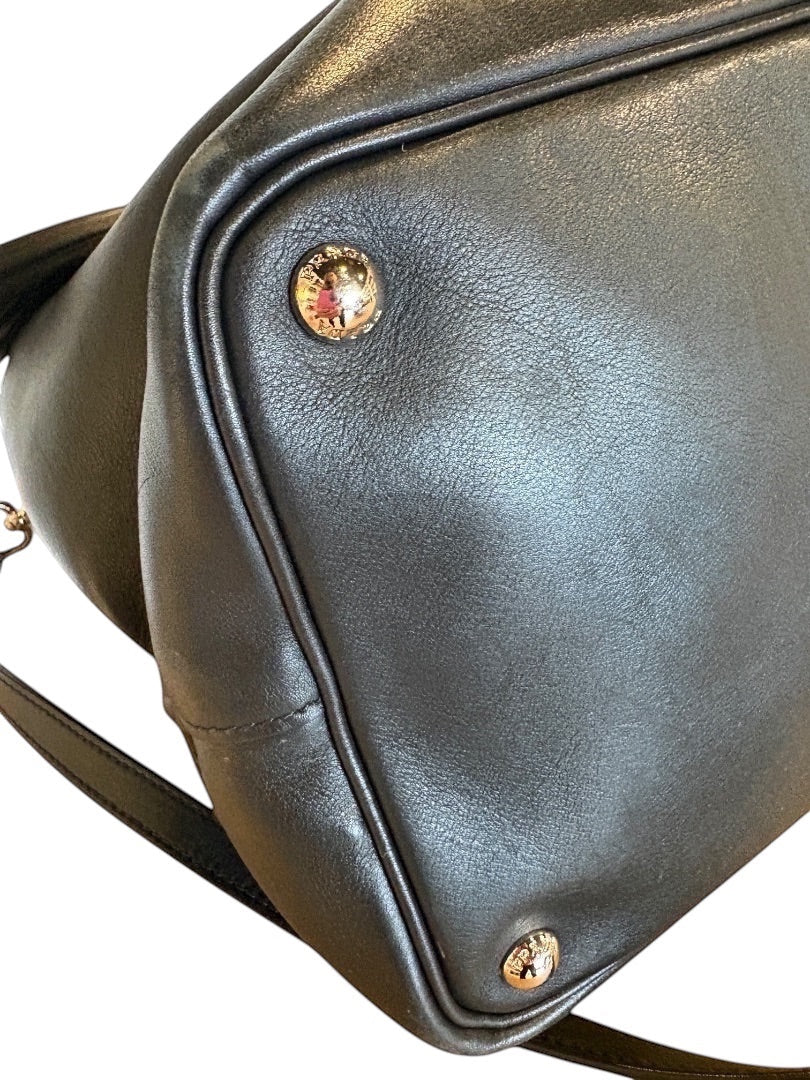 Posh Purse Co. black Prada leather bucket bag with gold logo hardware and strap.