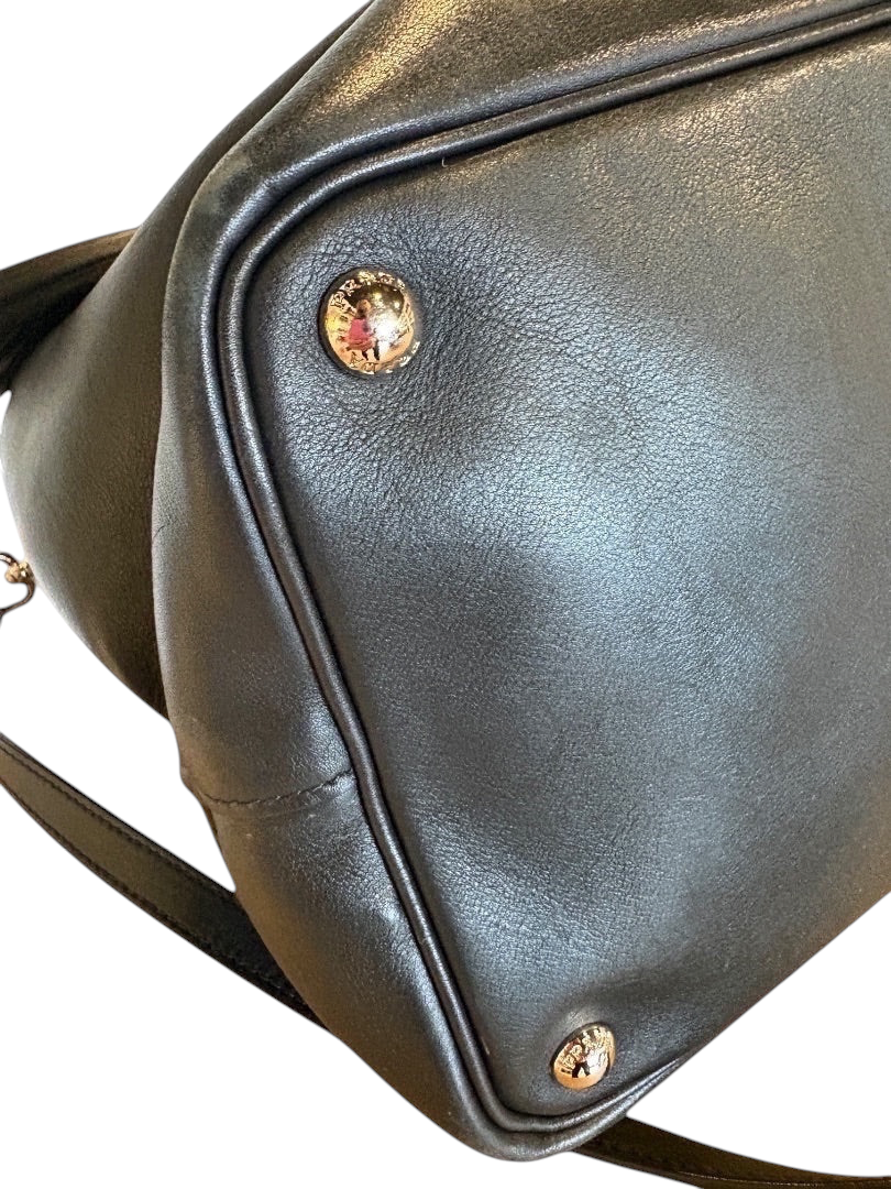 Posh Purse Co. black Prada leather bucket bag with gold logo hardware and strap.