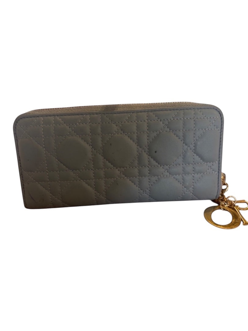 Posh Purse Co. blue leather Dior Voyageur wallet with Cannage quilting and gold D charm. Shows exterior ink marks.