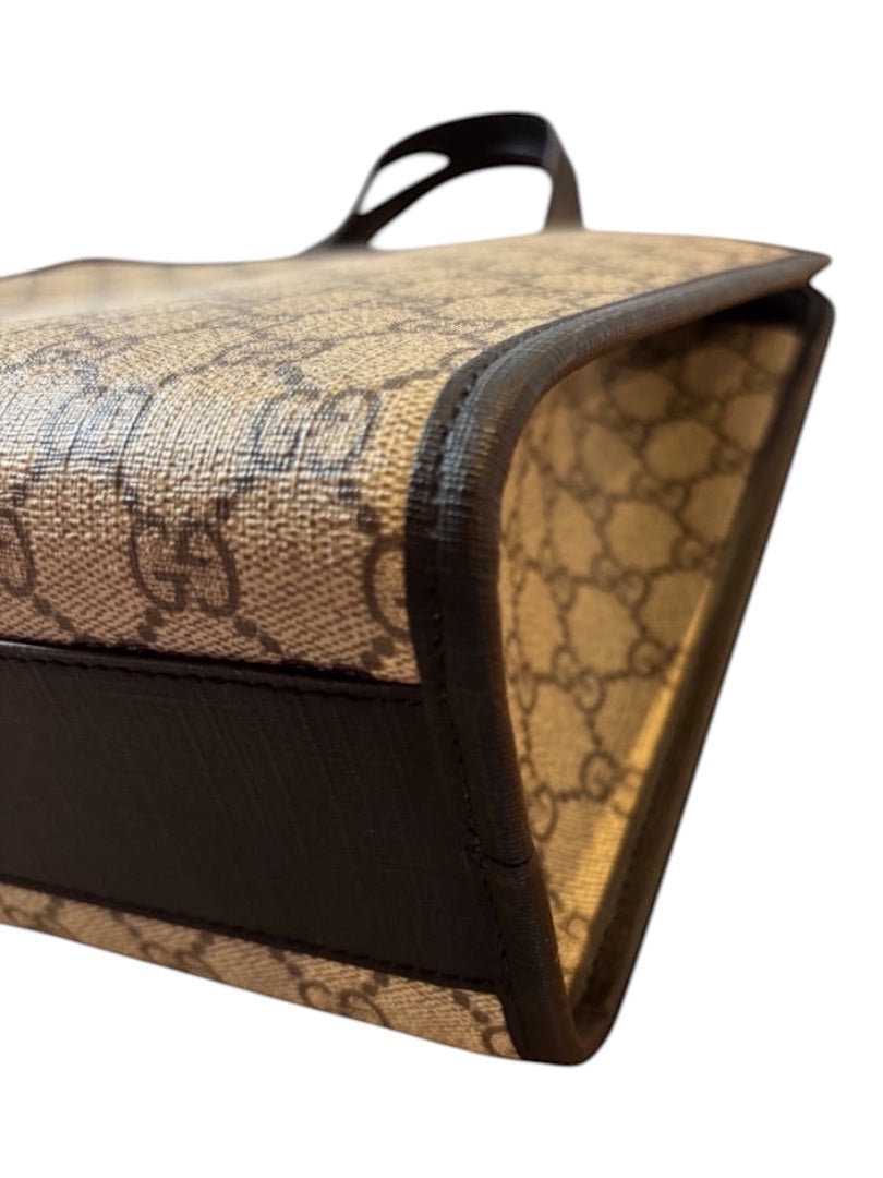 Posh Purse Co Gucci Children's GG Supreme canvas tote bag with brown leather trim and iconic GG pattern.