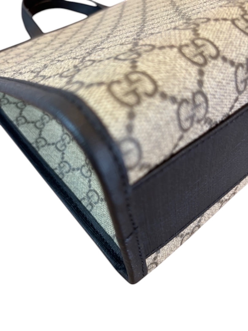 Posh Purse Co Gucci Children's GG Supreme canvas tote bag with brown leather trim and iconic GG pattern.