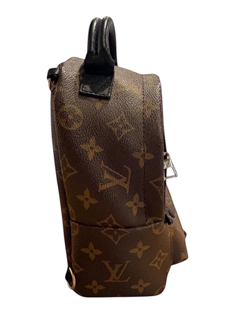 Posh Purse Co Louis Vuitton Palm Springs Mini backpack in Monogram canvas with black leather trim and top handle.