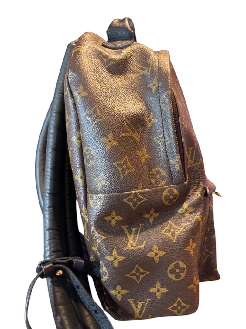 Posh Purse Co Louis Vuitton Palm Springs backpack in monogram coated canvas with black leather trim and adjustable straps.
