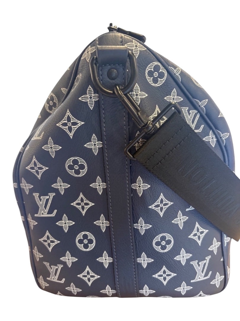 Posh Purse Co navy blue Louis Vuitton Monogram Shadow calfskin leather Keepall 50 travel bag with white embossed pattern and black strap.