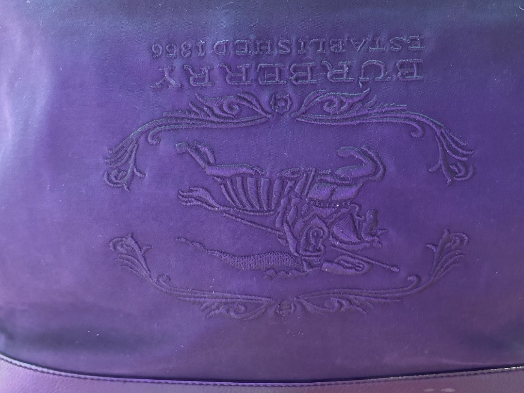 Posh Purse Co. purple Burberry tote bag with embroidered equestrian knight motif and established 1866 detail.