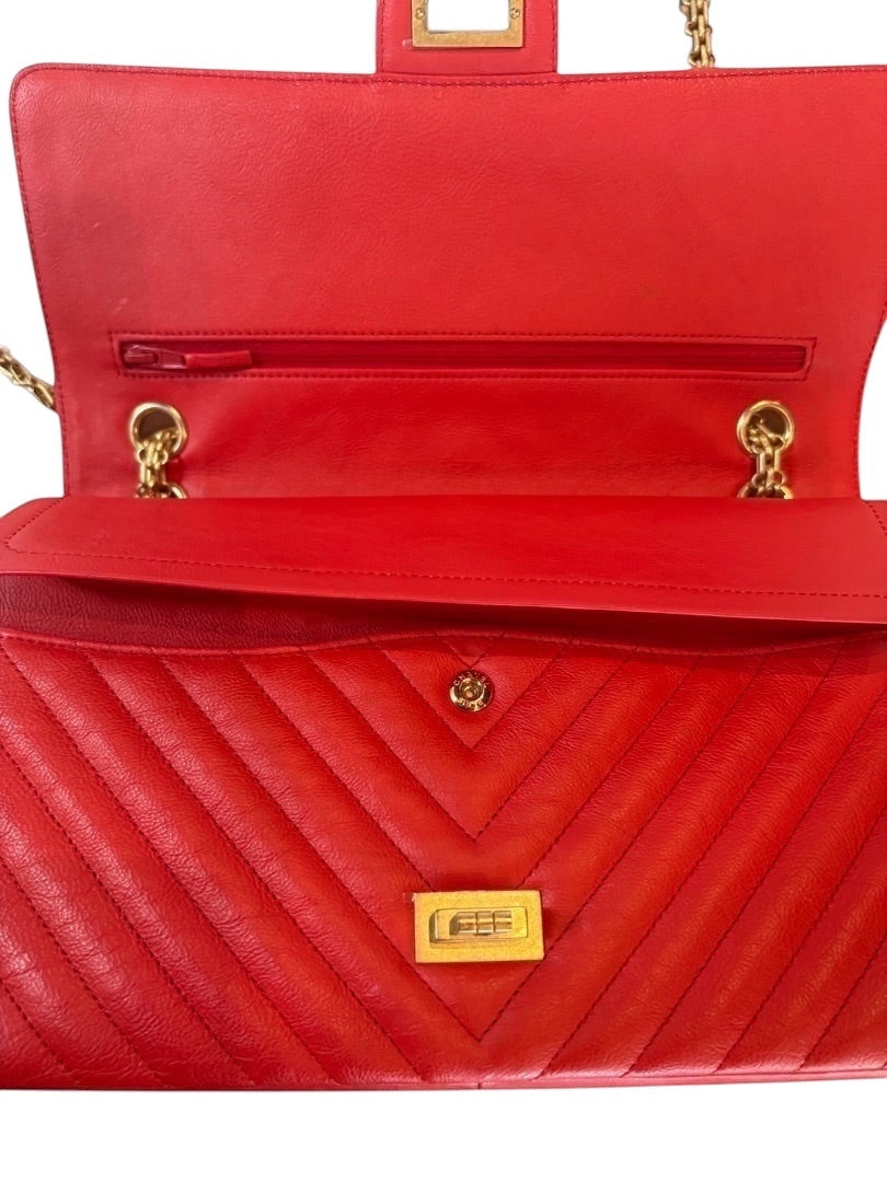 Posh Purse Co. red chevron quilted leather Chanel 2.55 Reissue double flap bag with gold hardware and Mademoiselle lock.